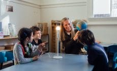 Montessori 6–12 diploma training – teacher presenting the world globe, showing how the Earth orbits the sun