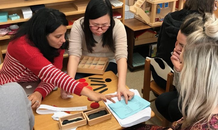 Montessori AMI 3–6 diploma training – student teachers practicing language material presentations together
