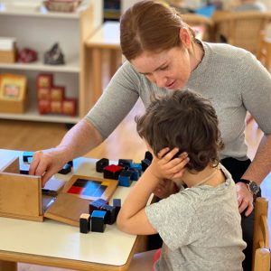 Montessori educator giving a lesson to a 5-year-old child